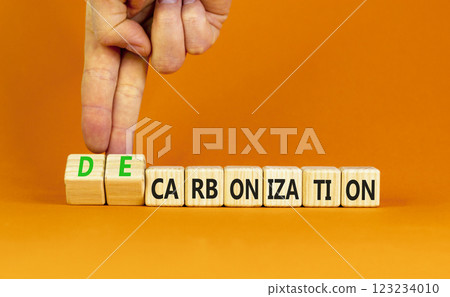 Decarbonization or carbonization symbol. Concept words Decarbonization or Carbonization on wooden blocks. Beautiful orange background. Business decarbonization or carbonization concept. Copy space. Decarbonization or carbonization symbol. Concept words Decarbonization or Carbonization on wooden blocks. Beautiful orange background. Business decarbonization or carbonization concept. Copy space. 123234010