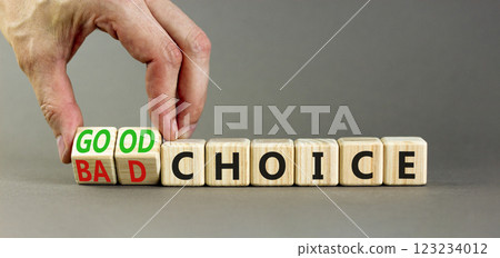 Good or bad choice symbol. Concept words Good choice or Bad choice on beautiful wooden blocks. Beautiful grey table grey background. Businessman hand. Business good bad choice concept. Copy space. 123234012