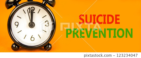 Suicide prevention symbol. Concept words Suicide prevention on beautiful orange paper. Black alarm clock. Beautiful orange paper background. Psychological and suicide prevention concept. Copy space. 123234047