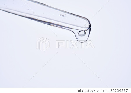 Pipette with delicate blue serum close-up. 123234287