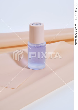 A bottle of blue serum on a delicate beige background. 123234289