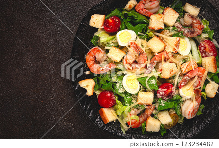 caesar salad with tiger prawns, shrimp salad, lettuce leaves, quail eggs, cherry tomatoes, parmesan cheese, on a black plate, caesar salad with tiger prawns, shrimp salad, lettuce leaves, quail eggs, cherry tomatoes, parmesan cheese, on a black plate, 123234482