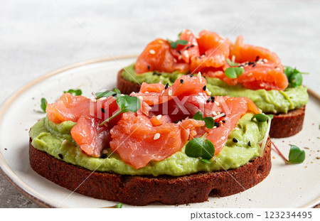 breakfast, Sandwiches with smoked salmon and avocado, on dark rye bread, with microgreens, on a marble table, homemade, no people, 123234495