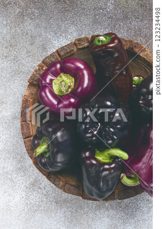 assortment of bell peppers, purple and black peppers, in a wooden bowl, top view, no people, 123234498