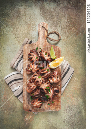 grilled baby octopus,with green onions, with lemon wedges, on a wooden chopping board, homemade, no people, grilled baby octopus,with green onions, with lemon wedges, on a wooden chopping board, homemade, no people, 123234508