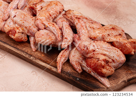 Chicken wings, marinated and laid out on a wooden platter, ready for cooking, grilling or baking, in a home kitchen, there are no people Chicken wings, marinated and laid out on a wooden platter, ready for cooking, grilling or baking, in a home kitchen, there are no people 123234534
