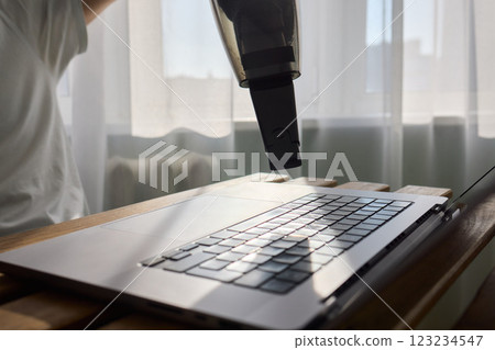 Using a handheld vacuum cleaner is an effective method for diligently cleaning a laptop Using a handheld vacuum cleaner is an effective method for diligently cleaning a laptop 123234547