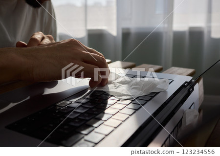 Meticulously Hand Cleaning Your Laptop with a Tissue to Achieve a Fresh and Neat Workspace 123234556