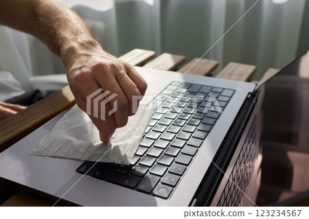 Meticulously Hand Cleaning Your Laptop with a Tissue to Achieve a Fresh and Neat Workspace Meticulously Hand Cleaning Your Laptop with a Tissue to Achieve a Fresh and Neat Workspace 123234567