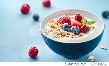 delicious yogurt with blueberries and raspberries on a blue background 123234637