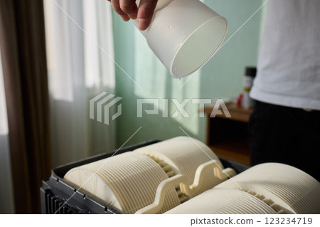 Pouring liquid into a storage container daily improves organization and efficiency Pouring liquid into a storage container daily improves organization and efficiency 123234719