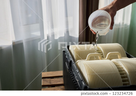 Pouring liquid into a storage container daily improves organization and efficiency 123234726