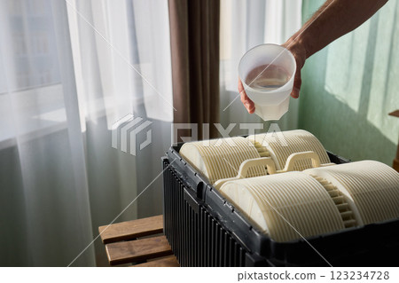 Pouring liquid into a storage container daily improves organization and efficiency 123234728