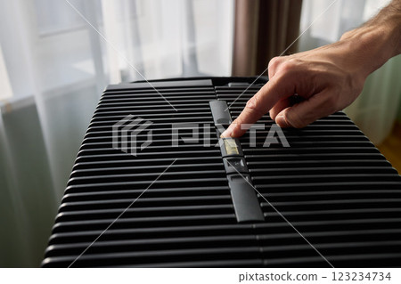 Hands adjusting a modern appliances control panel for optimal functionality and home comfort 123234734