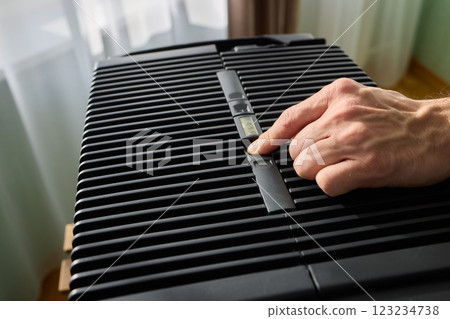 Hands adjusting a modern appliances control panel for optimal functionality and home comfort Hands adjusting a modern appliances control panel for optimal functionality and home comfort 123234738
