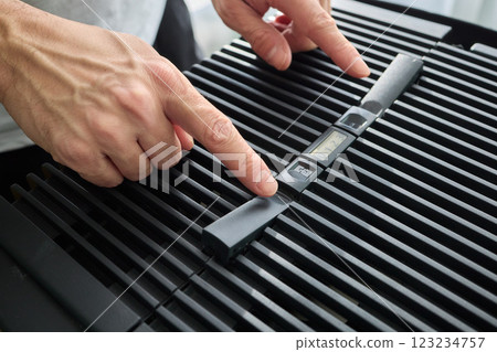 Hands adjusting a modern appliances control panel for optimal functionality and home comfort 123234757