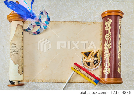 Purim Celebration Items. Festive Purim setup with Esther scrolls, Hamantaschen, and a mask 123234886