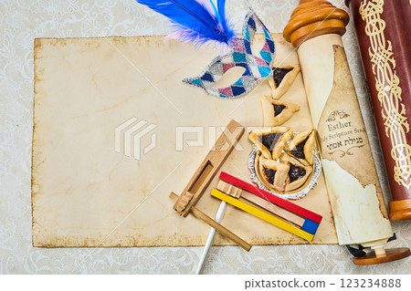 Purim Celebration Items. Festive Purim setup with Esther scrolls, Hamantaschen, and a mask Purim Celebration Items. Festive Purim setup with Esther scrolls, Hamantaschen, and a mask 123234888