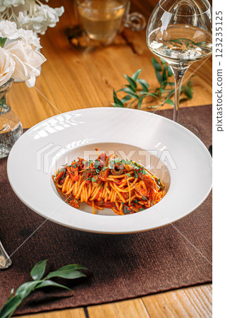 Spaghetti pasta with tomato sauce and olives 123235125