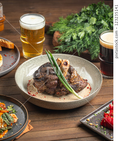 Portion of baked beef shank with pepper sauce 123235141