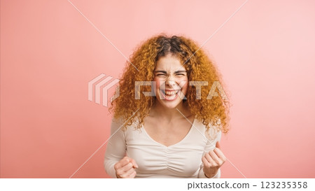 Enthusiastic young woman celebrating success with excitement and joy Enthusiastic young woman celebrating success with excitement and joy 123235358