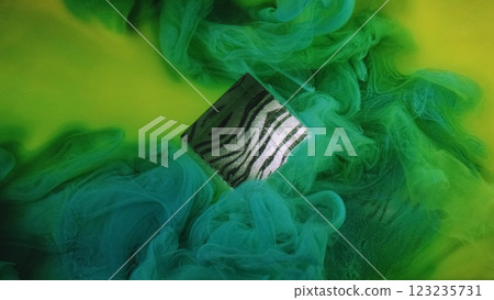 Abstract cube. Sparkle texture. Defocused blue green yellow multicolor haze fume fog paint splash ink on patterned light background. Abstract cube. Sparkle texture. Defocused blue green yellow multicolor haze fume fog paint splash ink on patterned light background. 123235731