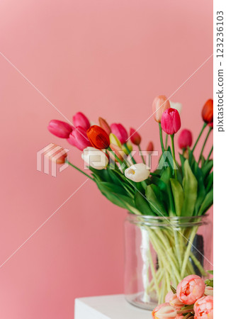 colored tulips on a pink background. bouquet of tulip buds in a glass vase on a colored background colored tulips on a pink background. bouquet of tulip buds in a glass vase on a colored background 123236103