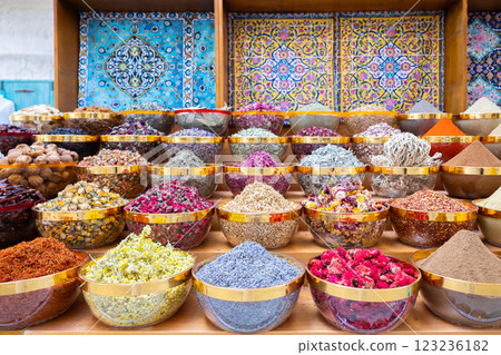 Traditional spices market. Pots and wooden tubs stand in row with colorful tea, spices, fruits, roots, flowers. Street bazaar. Dubai, UAE. Traditional spices market. Pots and wooden tubs stand in row with colorful tea, spices, fruits, roots, flowers. Street bazaar. Dubai, UAE. 123236182