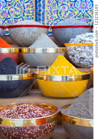 Traditional spices market. Pots and wooden tubs stand in row with colorful tea, spices, fruits, roots, flowers. Street bazaar. Dubai, UAE. Vertical photo Traditional spices market. Pots and wooden tubs stand in row with colorful tea, spices, fruits, roots, flowers. Street bazaar. Dubai, UAE. Vertical photo 123236183