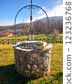 Beautiful well with flowers in the mountains 123236768