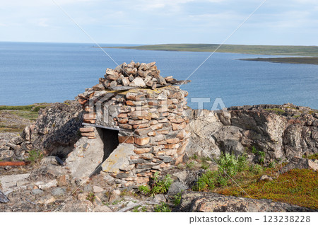 Old abandoned stone pillbox at seashore 123238228