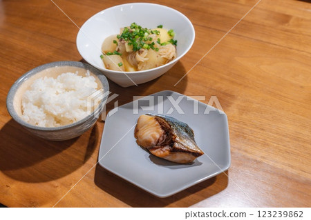 A dinner table with meat and potatoes and teriyaki yellowtail 123239862