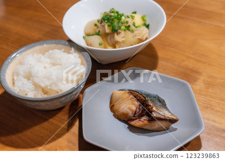 A dinner table with meat and potatoes and teriyaki yellowtail 123239863