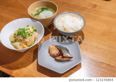 A dinner table with meat and potatoes and teriyaki yellowtail 123239864