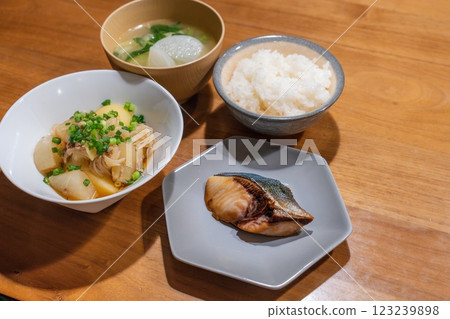 A dinner table with meat and potatoes and teriyaki yellowtail 123239898