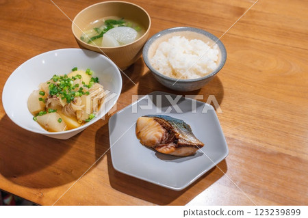 A dinner table with meat and potatoes and teriyaki yellowtail 123239899
