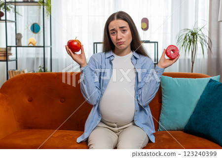 Choosing right nutrition pregnant woman comparing choosing between sweet donut and ripe apple 123240399