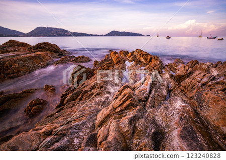 Long exposure image of Dramatic sky seascape with rock in sunset scenery background 123240828