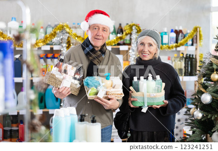 Elderly couple shopping for Christmas presents together at goods store Elderly couple shopping for Christmas presents together at goods store 123241251