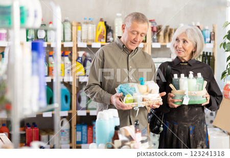 Elderly couple chooses gifts in supermarket for relatives and friends 123241318