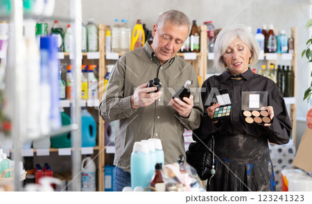 Senior couple, studies label and choose perfume and eye shadow pallet Senior couple, studies label and choose perfume and eye shadow pallet 123241323