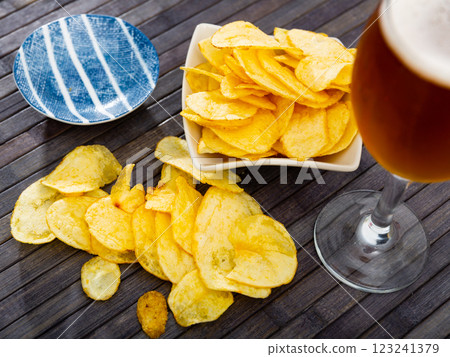 Potato chips and beer served on table Potato chips and beer served on table 123241379