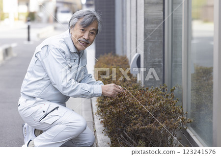 公寓和穿工作服的男人 123241576