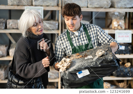 Older woman choosing mycelium in a garden store 123241699