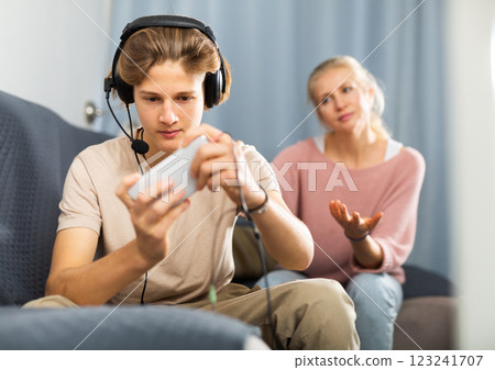 Mother asking for attention of her teenager son Mother asking for attention of her teenager son 123241707