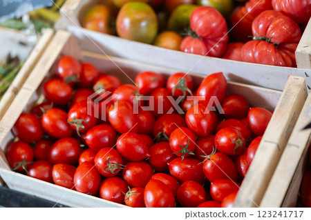 Fresh red tomatoes displayed in crates on market stall 123241717