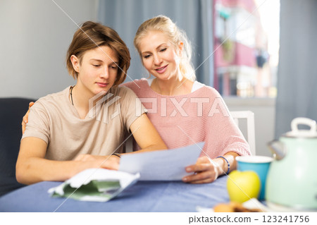Happy mother and son reading letter from school 123241756