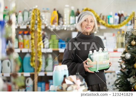 Elderly woman buyer chooses cosmetics gift set for christmas 123241829