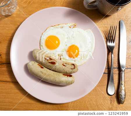 Homemade hearty breakfast - fried eggs with frankfurter sausages. Homemade hearty breakfast - fried eggs with frankfurter sausages. 123241959