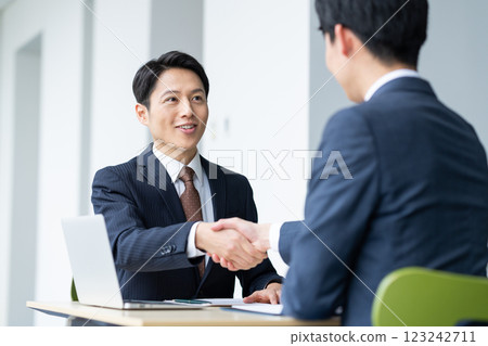 Businessmen shaking hands. Photo courtesy of Sky Perfect TV Tokyo Media Center. 123242711